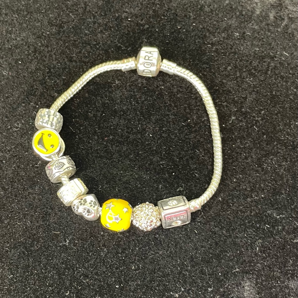 Authentic Pandora Silver Charm Bracelet with 8 charms.